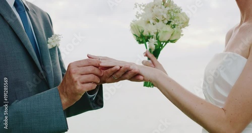 Bride and groom exchanging rings on wedding day