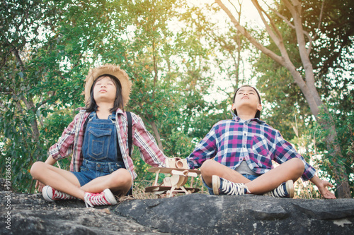 Asian girl and boy playing in nature , Relax time on holiday concept travel,selective and soft focus,tone of hipster style