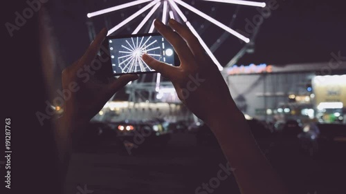 Hands recording amusement park on smart phone