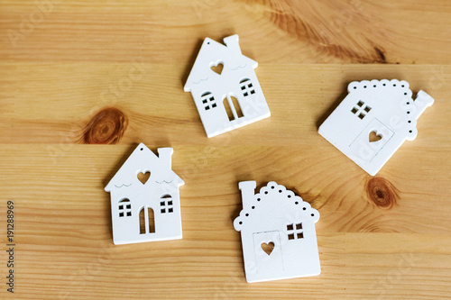 Small White Houses Models On Wooden Background