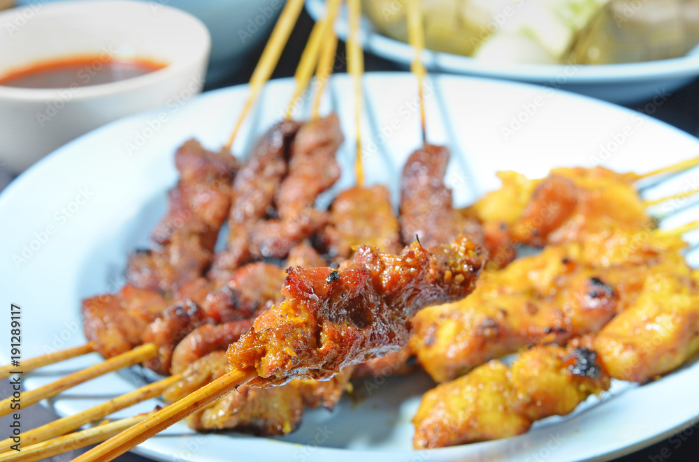 Beef and chicken satay  on a plate