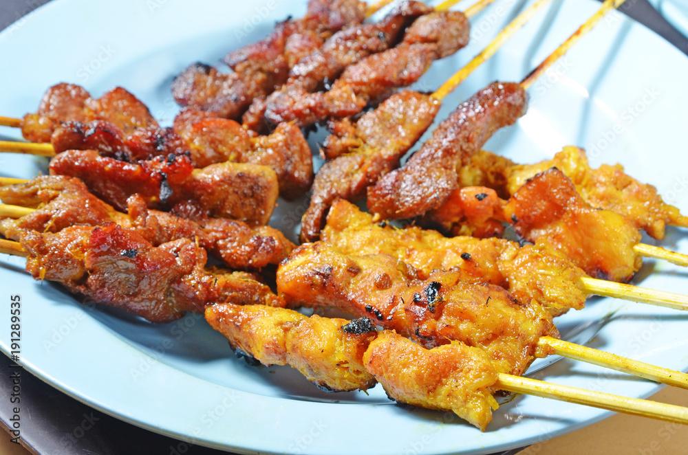 Beef and chicken satay on a plate Beef and chicken satay on a plate