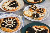 Yeast cake with almond, raisin, poppy and cheese on plate and dish towel