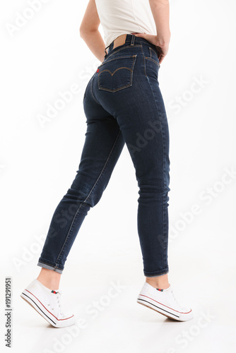 Half portrait of a woman dressed in t-shirt and jeans