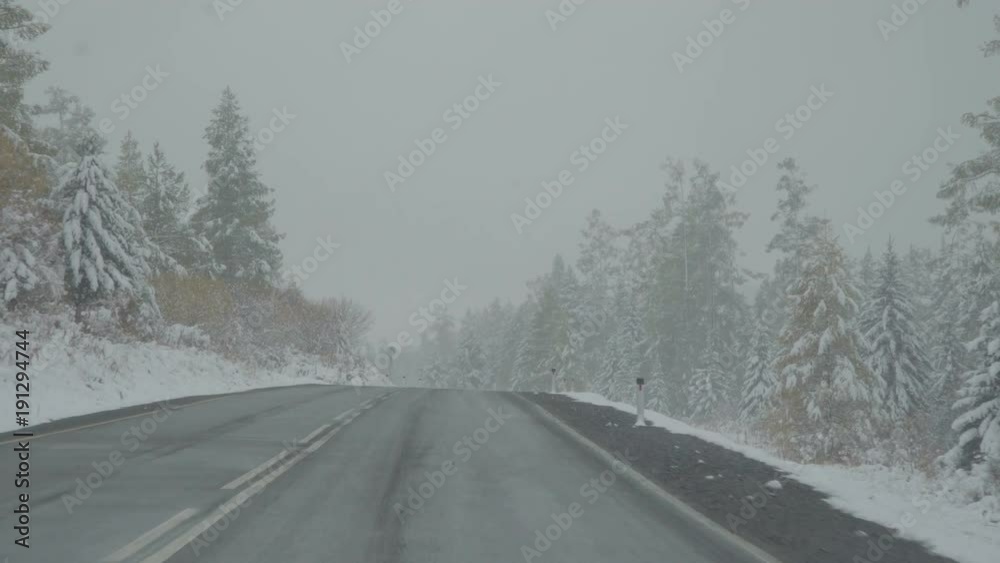 Driving car on winter mountain road snow fall POV Driving car on winter mountain road snow fall POV
