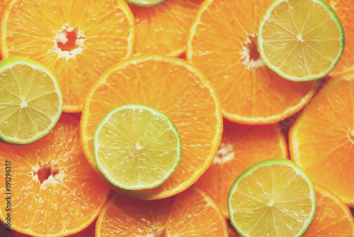 Fresh sliced orange fruit texture. Macro  top view  copy space. Food frame. Juicy oranges and lime background