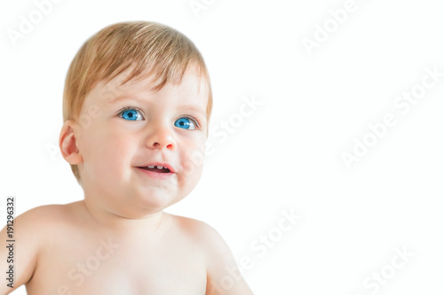 Happy blonde baby boy with blue eyes on a white background. Isolated