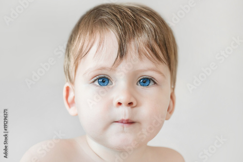 Portrait of a blonde baby boy with blue eyes