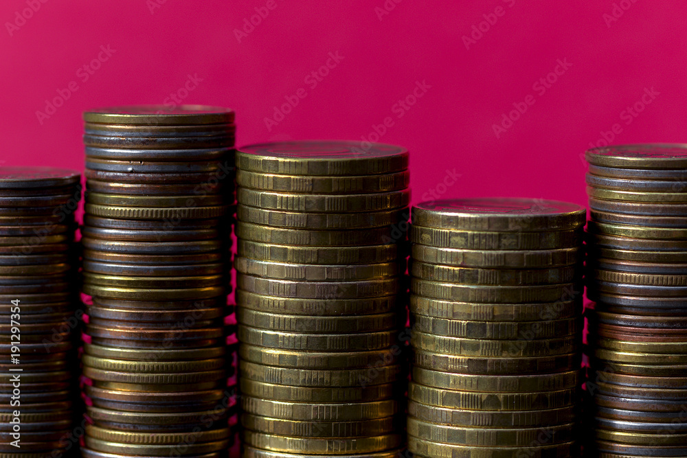 Stacks of coins on a pink background Stacks of coins on a pink background