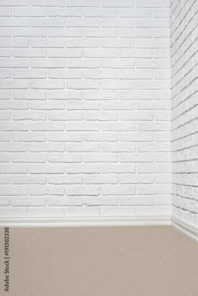Fototapeta premium the corner of the room with white brick wall and floor, abstract background photo