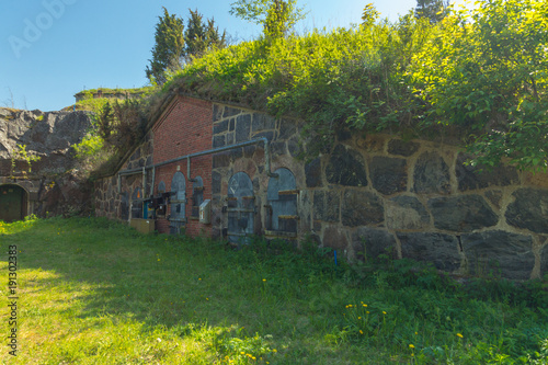 An old fortification construction on a bright summer day on Vallisaari island in Finland photo