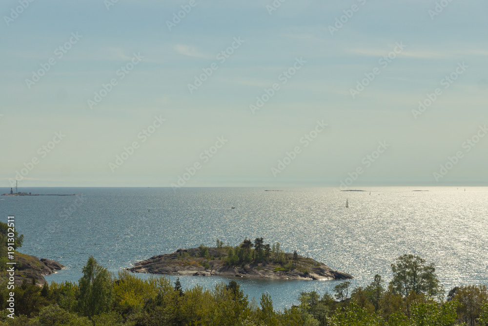 A panoramic view on a little island and open sea with many boats and yachts sailing in the Baltic sea, Finland, Europe A panoramic view on a little island and open sea with many boats and yachts sailing in the Baltic sea, Finland, Europe