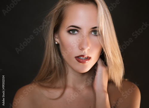 Portrait of beautiful sensual woman with green eyes. Studio shot.