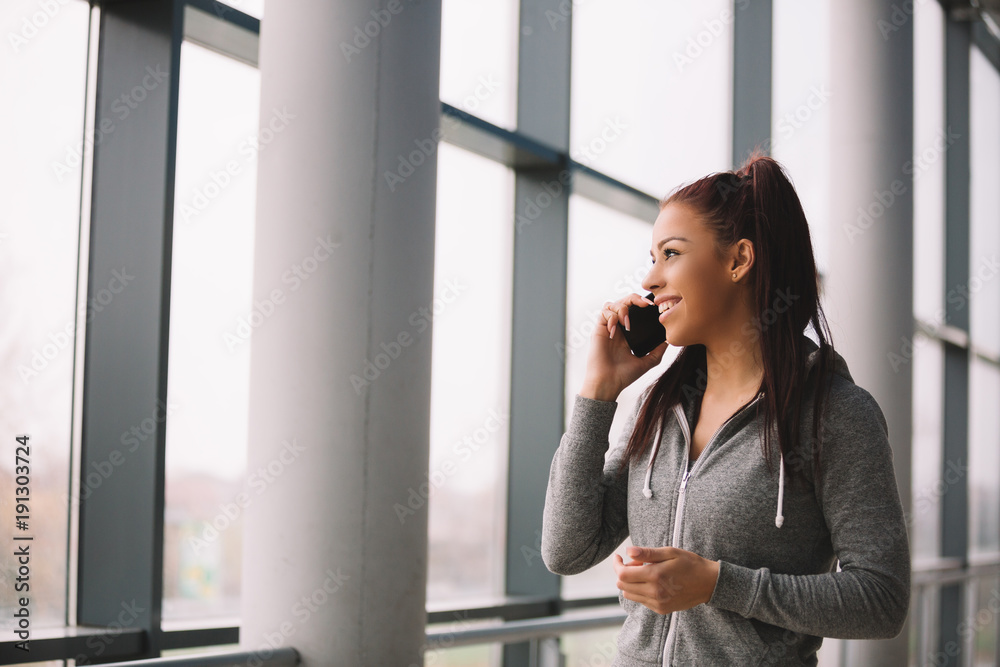 Young fit girl using mobile. Young fit girl using mobile.