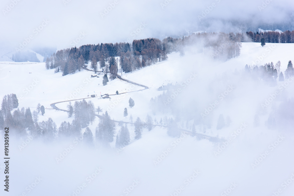 Dolomites. Winter views in the fog and low clouds Dolomites. Winter views in the fog and low clouds