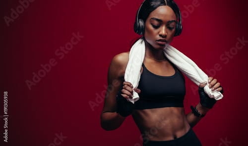 Fototapeta Naklejka Na Ścianę i Meble -  African female athlete listening music after workout