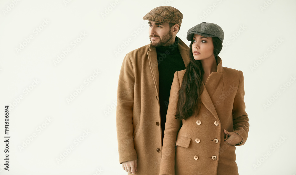 Portrait of a loving couple dressed in a yellow fashion coat - obrazy, fototapety, plakaty 