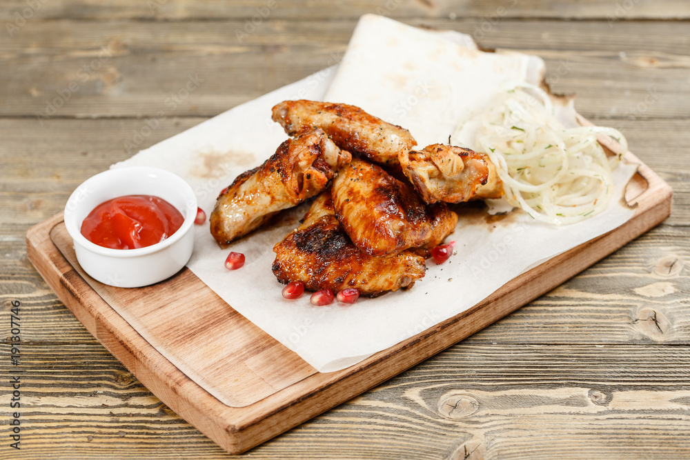 chicken wings grill. Serving on a wooden Board on a rustic table. Barbecue restaurant menu, a series of photos of different meats