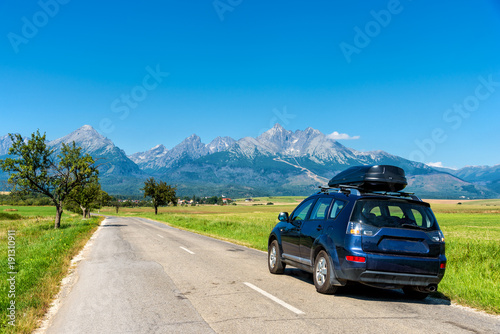 car for traveling with a roof rack on a mountain road
