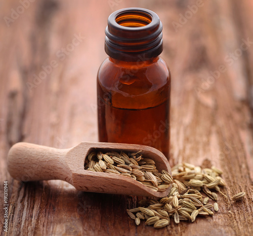 Fennel seeds with essential oil in a bottle