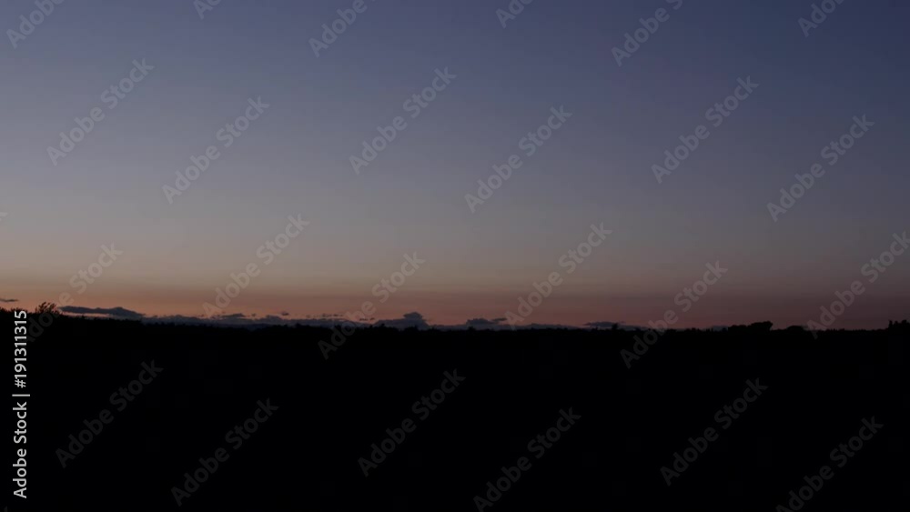 Tractor drives by several times against early morning sky. Tractor drives by several times against early morning sky.