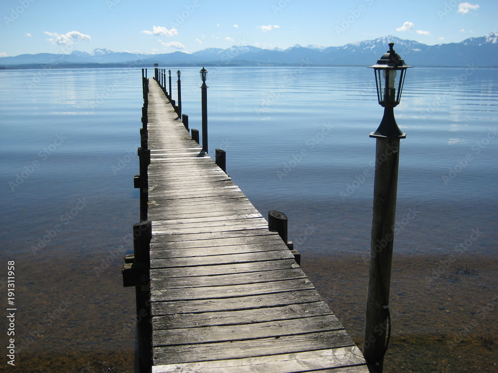 Jetty at Chiemsee in Bavaria, Germany, view to the alps Jetty at Chiemsee in Bavaria, Germany, view to the alps