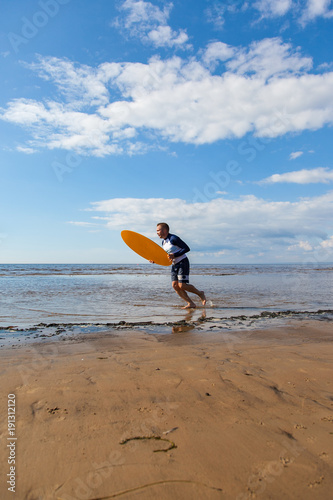 Young man skimboarding photo