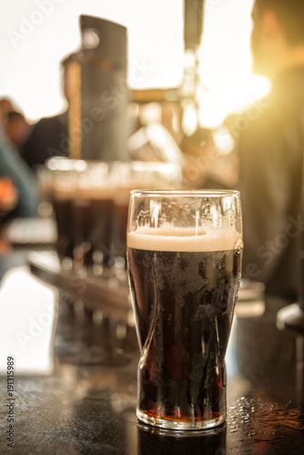 Close up of a glass of stout beer in a bar