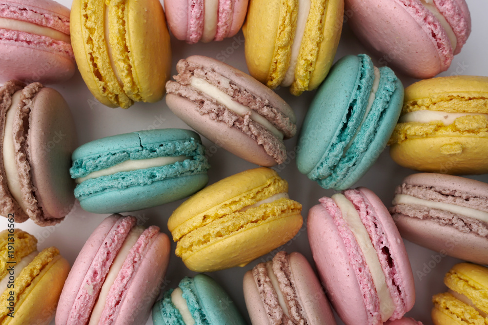 Pink, beige and blue macaroons, flat lay style. Colorful almond cookies. Pastel cake macarons background. Pink, beige and blue macaroons, flat lay style. Colorful almond cookies. Pastel cake macarons background.