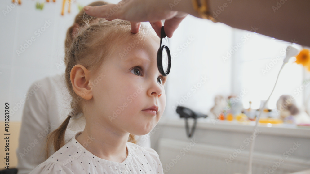 Check up of eyesight in child's ophthalmology - optometrist diagnosis little girl Check up of eyesight in child's ophthalmology - optometrist diagnosis little girl