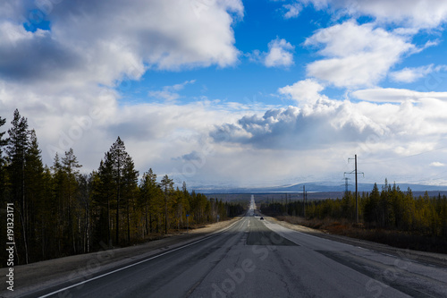 Long stretch of flat highway in Saskatchewan prairies, Canada photo