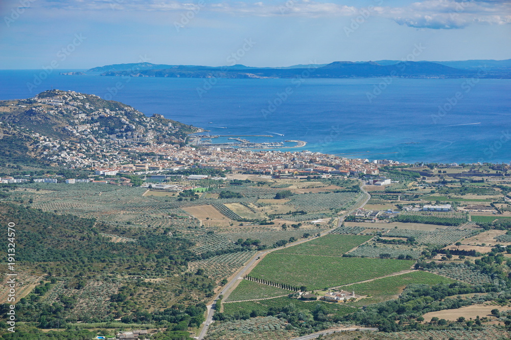Spain aerial view over the city of Roses on the shore of the Mediterranean sea with olive groves and vineyards fields, Costa Brava, Girona, Catalonia, Alt Emporda