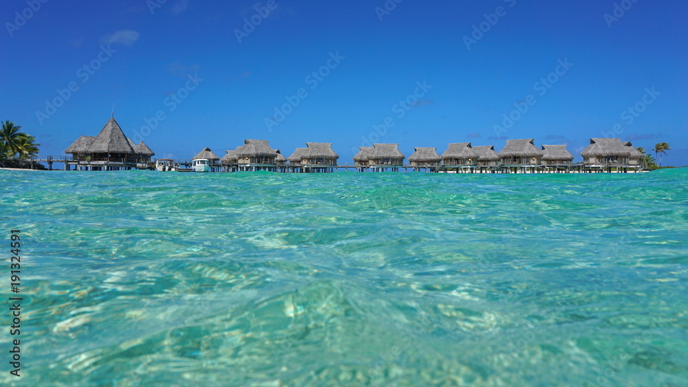 Tropical resort with thatched bungalows in the lagoon seen from sea surface, Tikehau atoll, Tuamotus, French Polynesia, Pacific ocean, Oceania Tropical resort with thatched bungalows in the lagoon seen from sea surface, Tikehau atoll, Tuamotus, French Polynesia, Pacific ocean, Oceania