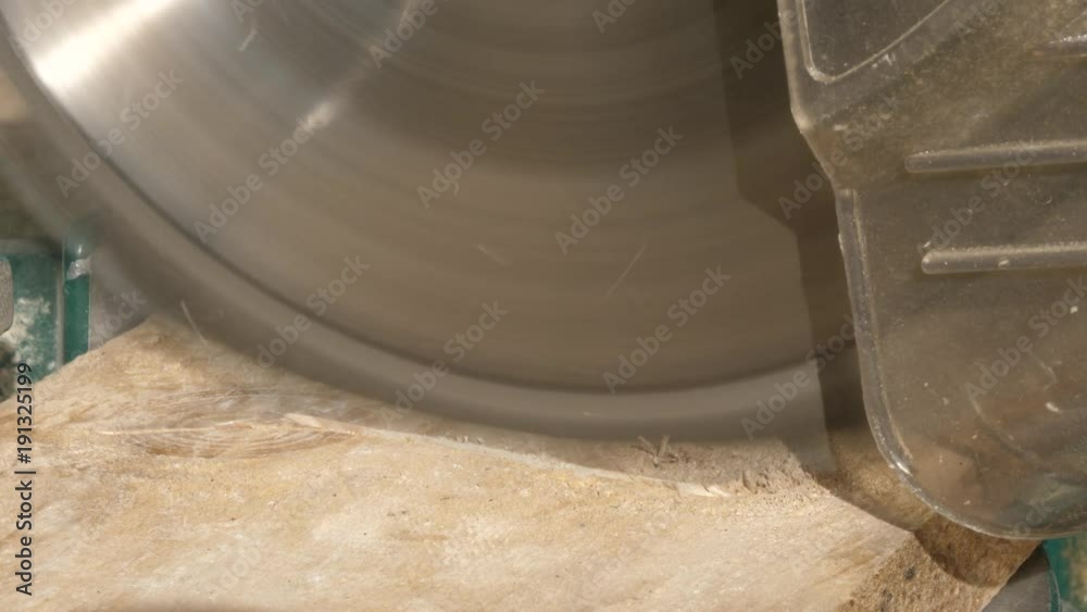 Cutting a wooden plank with hand circular saw. 10 bit Cutting a wooden plank with hand circular saw. 10 bit