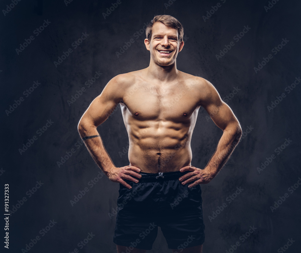 Studio portrait of a shirtless athletic tattooed male