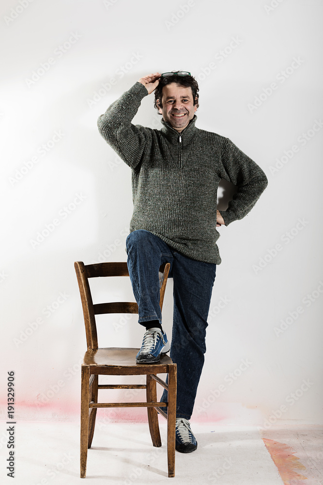Adult man interacts with a chair Adult man interacts with a chair