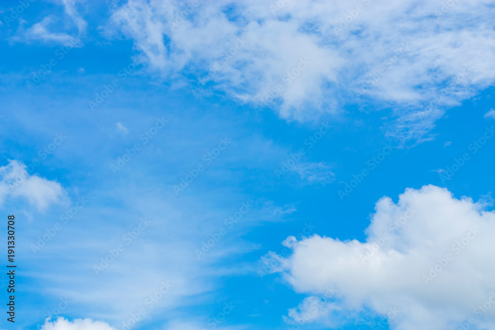 Blue sky background with tiny clouds. White fluffy clouds in the blue sky Blue sky background with tiny clouds. White fluffy clouds in the blue sky