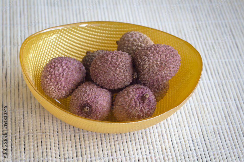 Fruit litchi in a yellow bowl. Fruit litchi in a yellow bowl.