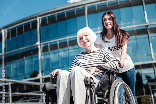 Happy smile. Joyful nice aged woman smiling and looking at you while being in a positive mood