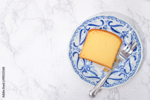 Slice of butter cake on blue plate
