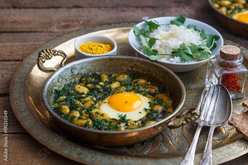 Iranian breakfast made with eggs, bean and dill photo