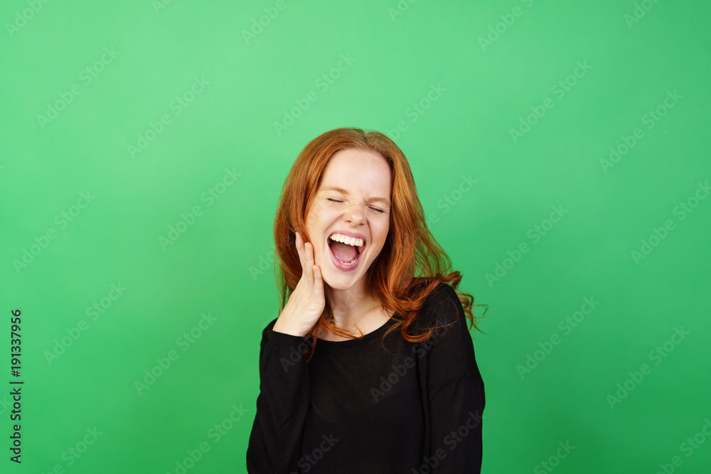 Young woman with red hair laughing Young woman with red hair laughing