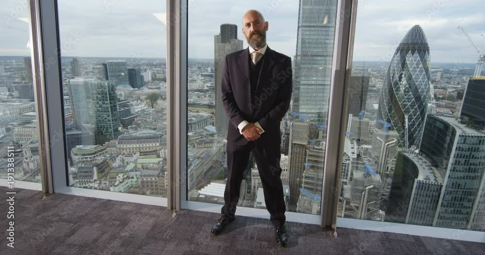 4k, Portrait of a successful businessman in a modern office building with London skyline in the background. Slow motion. 4k, Portrait of a successful businessman in a modern office building with London skyline in the background. Slow motion.