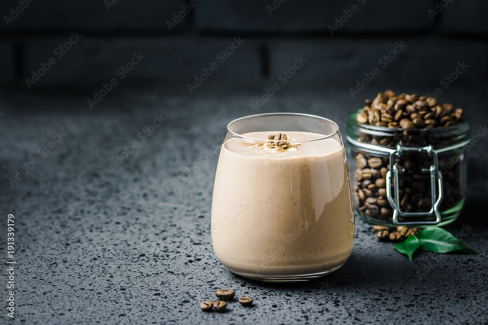 Φωτογραφία Vegan coconut milk banana coffee smoothie and coffee beans in glass jar on dark concrete background