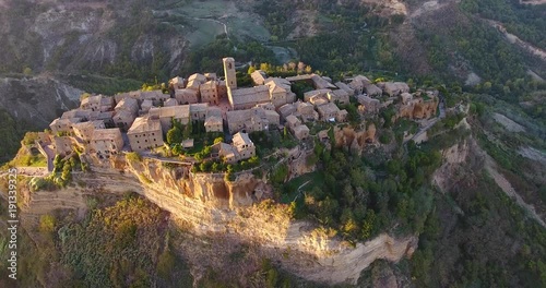 Aerial, beautiful town on atop a plateau Civita di Bagnoregio in province of Viterbo in central Italy with a beautiful sunset light
