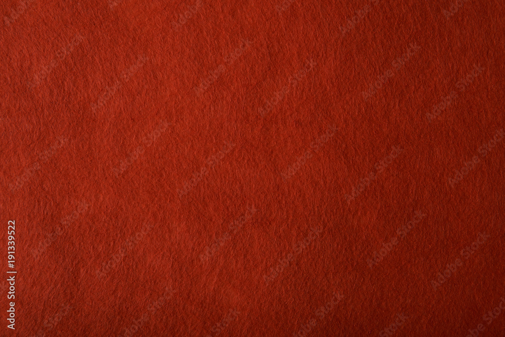 Fragment of the surface of fibrous synthetic non-woven material of red color. Background, texture Fragment of the surface of fibrous synthetic non-woven material of red color. Background, texture