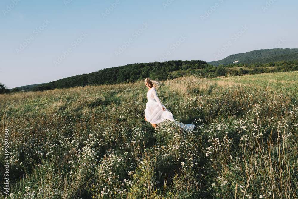 Fototapeta premium Beautiful bride walking outdoor