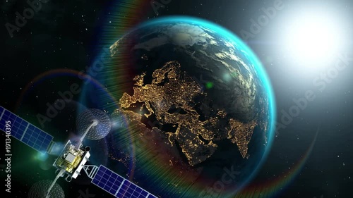 Sunrise from space on background, fictional observation satellite flies past, 3d animation. Texture of Earth was created in graphic editor without photos. Pattern of city lights furnished by NASA.