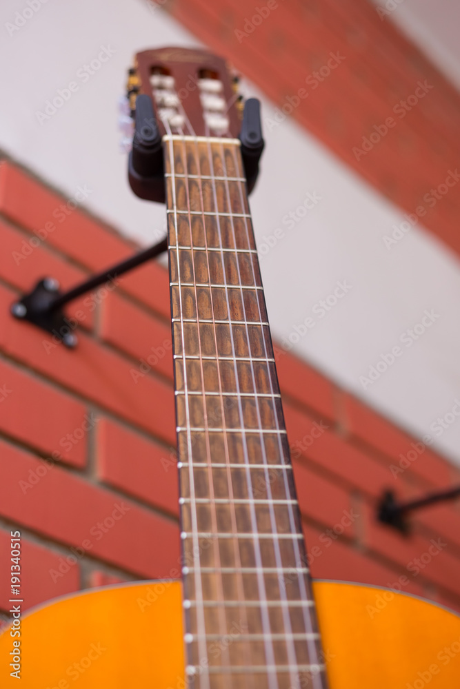 Classic guitar hanged on the wall Classic guitar hanged on the wall