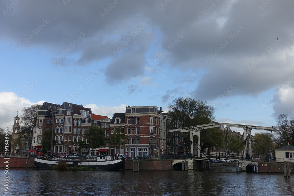 Houses and Walter Suskindbrug next to Amstel river in Amsterdam Houses and Walter Suskindbrug next to Amstel river in Amsterdam